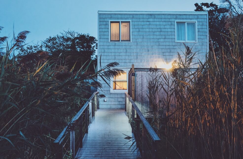 beach house among tall grass at dusk